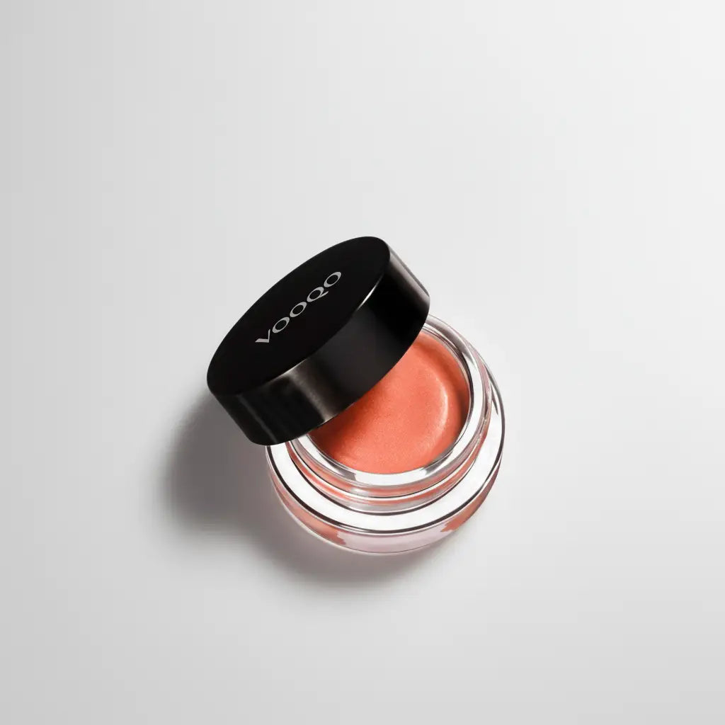 Voodoo cream blush coral in a sleek black and clear glass jar with a glossy finish perfect for a natural glow