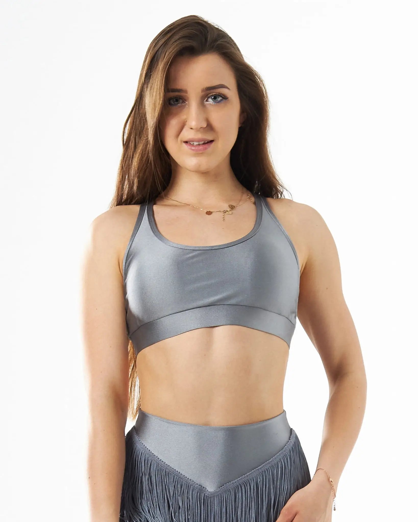 Gray satin sports bra with racerback design and matching high-waisted fringe skirt perfect for circuit under the bust